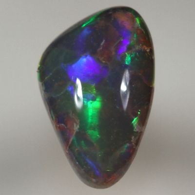 SOLID SEMI BLACK OPAL Large, bright rolling flashes of orange, green and blue